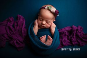 Luxury newborn photography Lexington, SC; professional portrait studio; jewel tone newborn girl photoshoot with peacock blue & royal purple