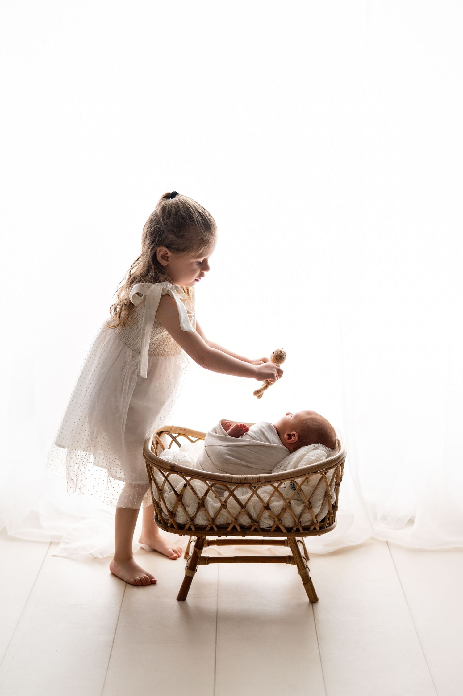 Collection of professional newborn portrait prints being held in hand.