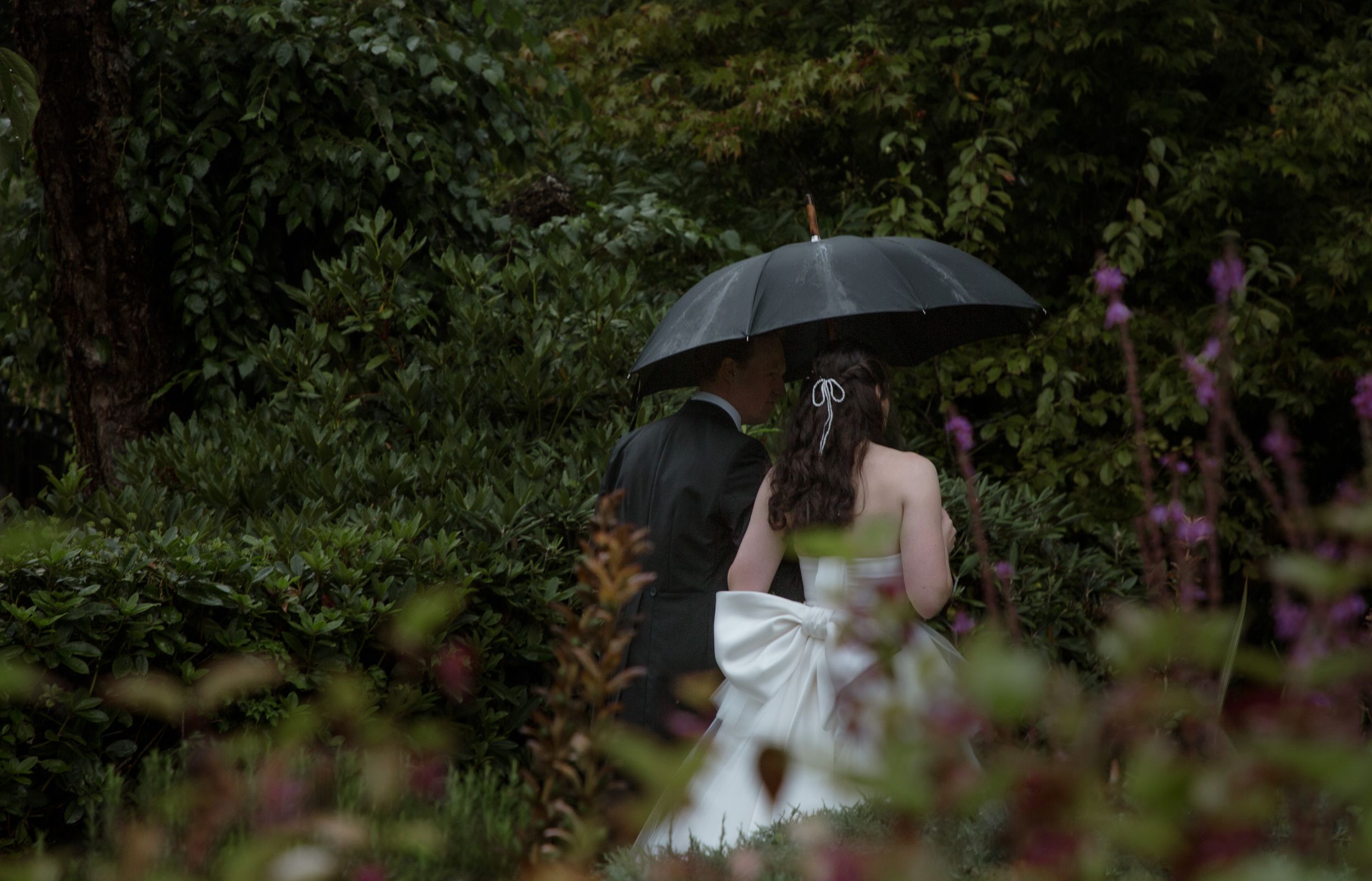 love bride and groom wedding portraits umbrella walking in the rain luxury wedding photography candid wedding photography