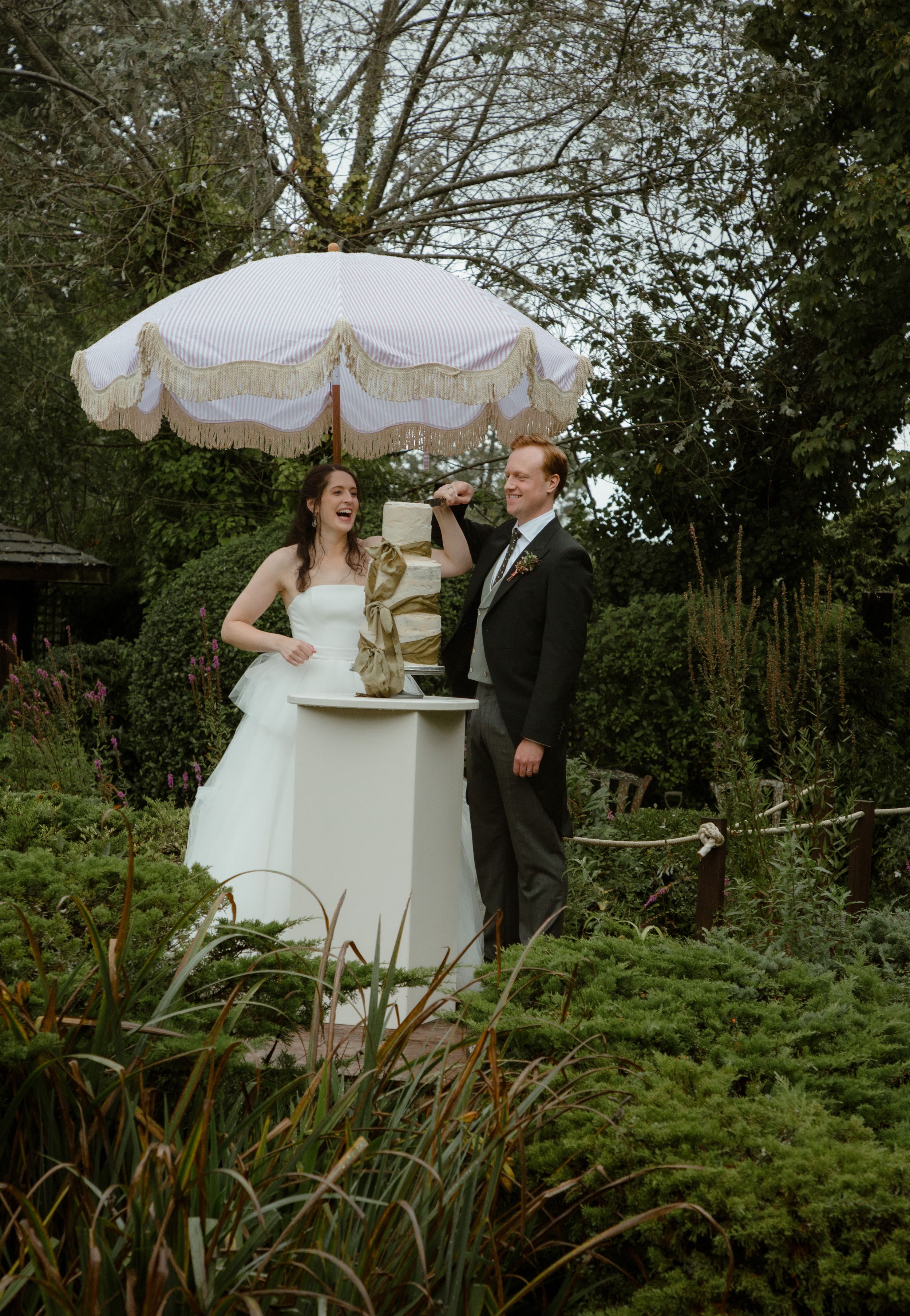 bride and groom wedding cake cutting traditions September wedding documentary wedding photographer