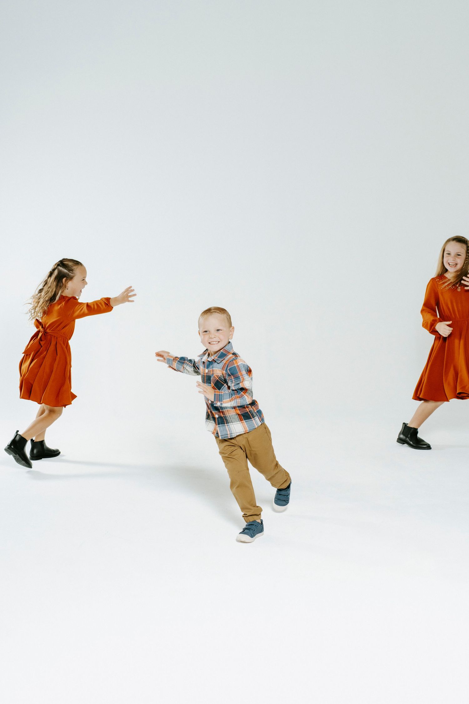 A series of dynamic jumping movements featuring a boy in khaki pants and plaid shirt against a white backdrop.