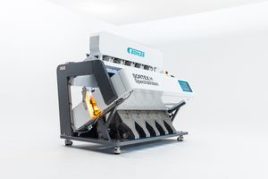 Modern industrial sorting machines with optical sensors and chutes shown in sleek white design against light background.