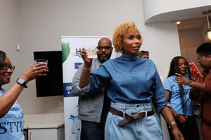 People interacting and networking at an indoor gathering with white walls and modern decor.
