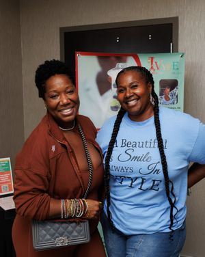 Two friends sharing a joyful moment while posing together in casual attire.