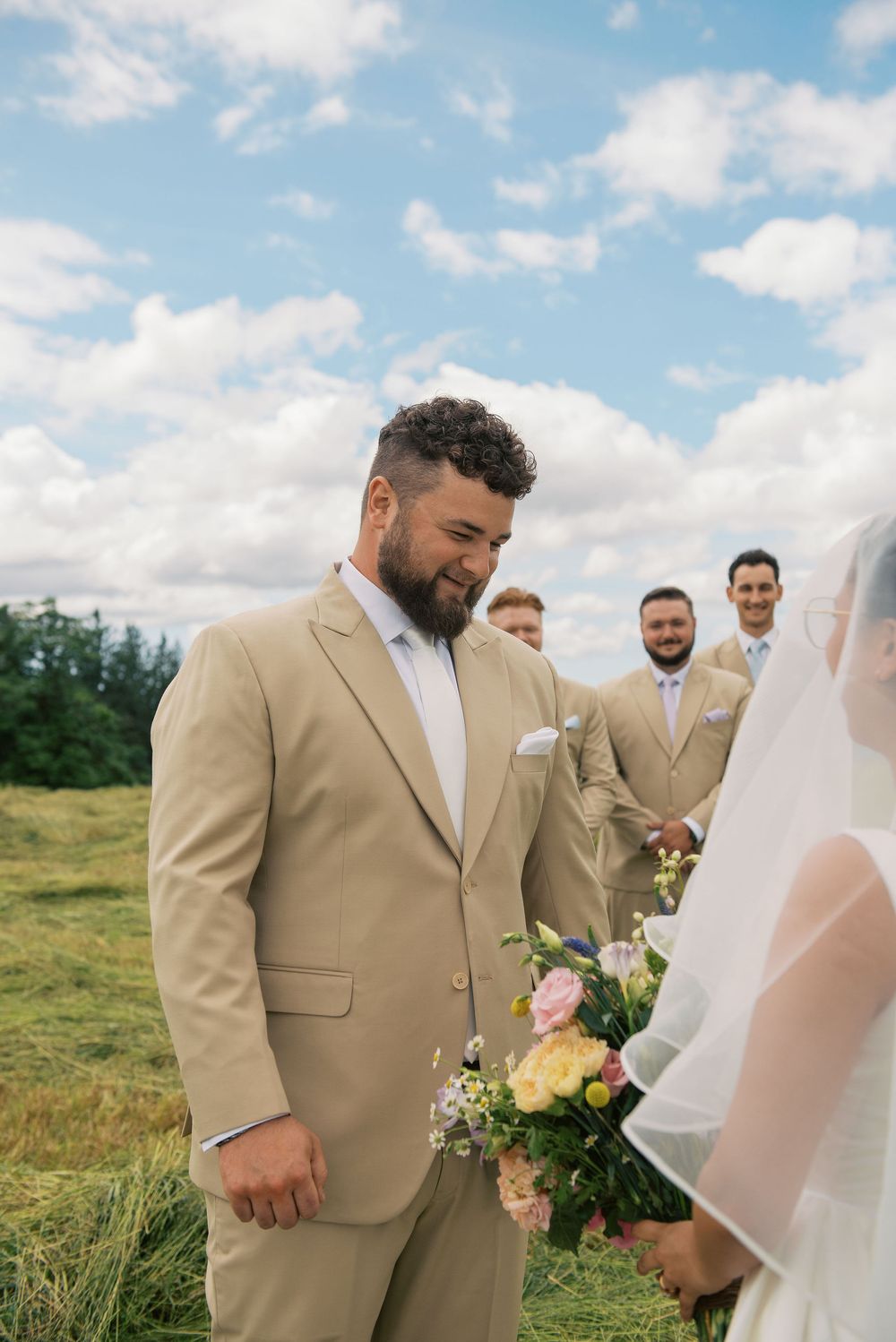 Wedding couple during first look moment in outdoor meadow setting.