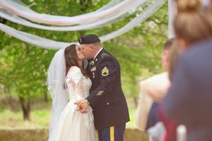 A series of romantic wedding photographs showing a couple embracing during their outdoor ceremony in a green setting.