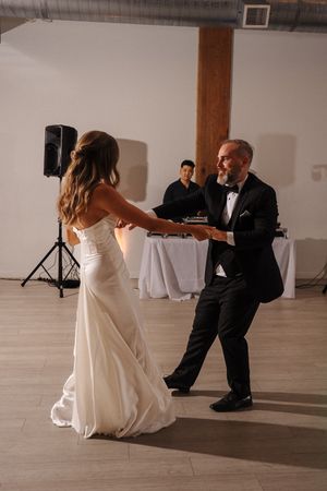 A sequence of dance poses between two people in formal attire performing on a minimalist dance floor.