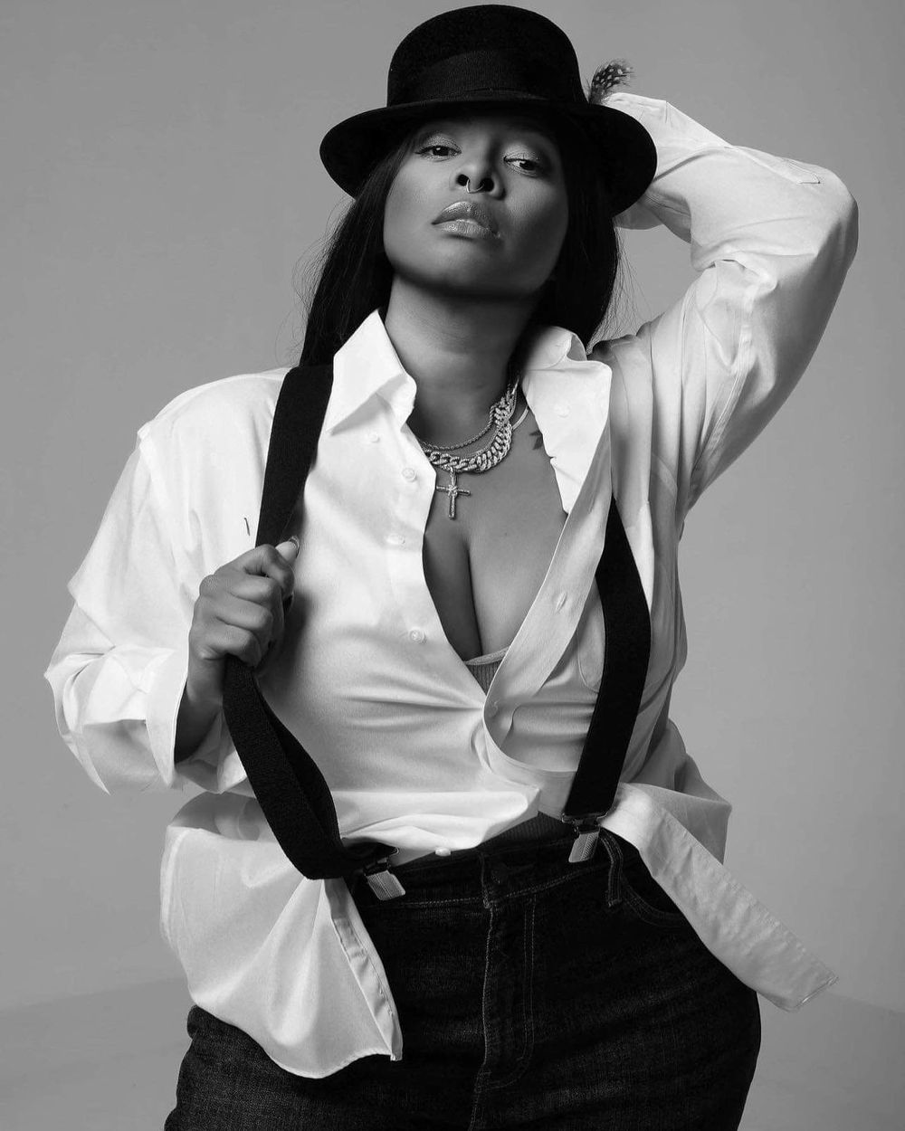 Black and white portrait series featuring white shirt, black hat and suspenders.