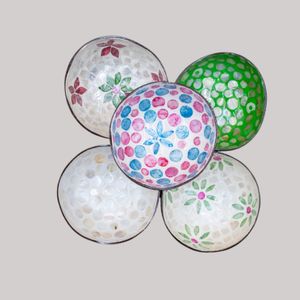 A photo shows decorative polka dot and floral print balls gradually fading away against a light gray background.