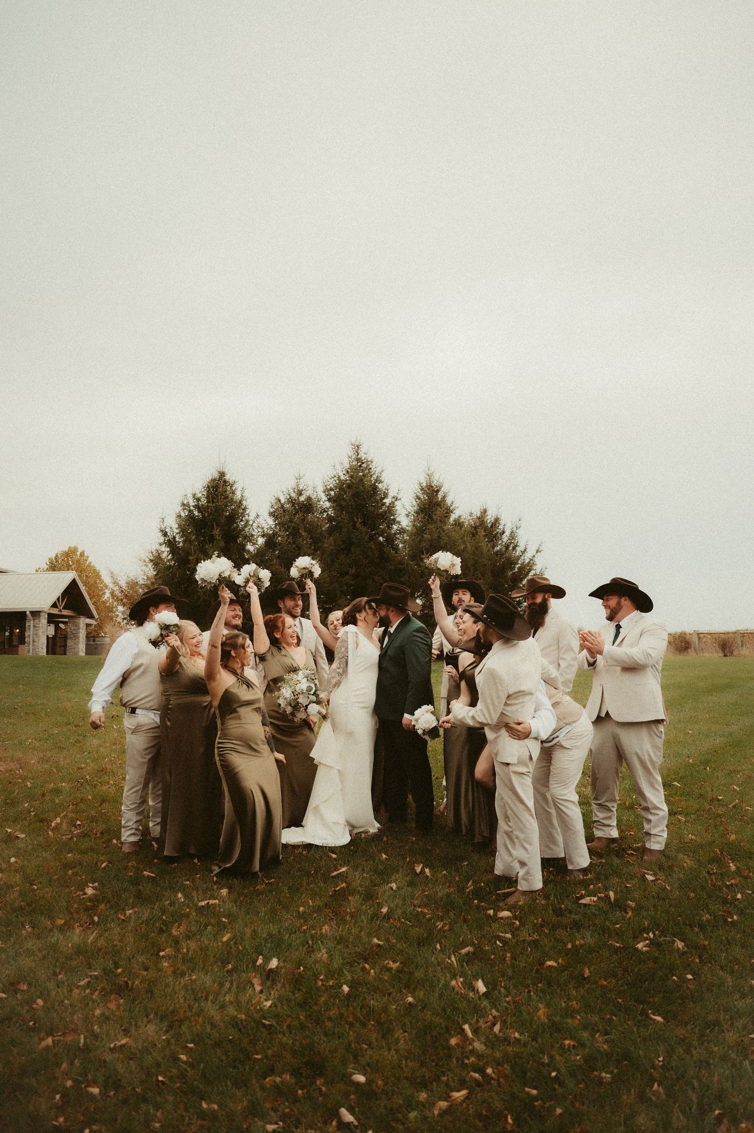 Indiana Wedding and Elopement Photographer // Wedding party celebrates on a grassy hillside during a winter outdoor ceremony.