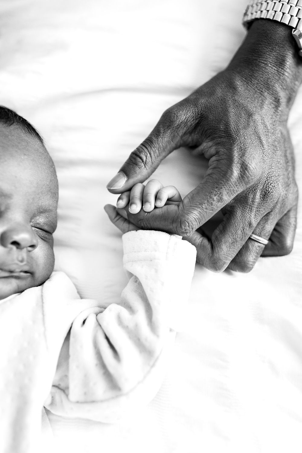 Minimalist baby photo showing organic, intimate newborn details with no styling