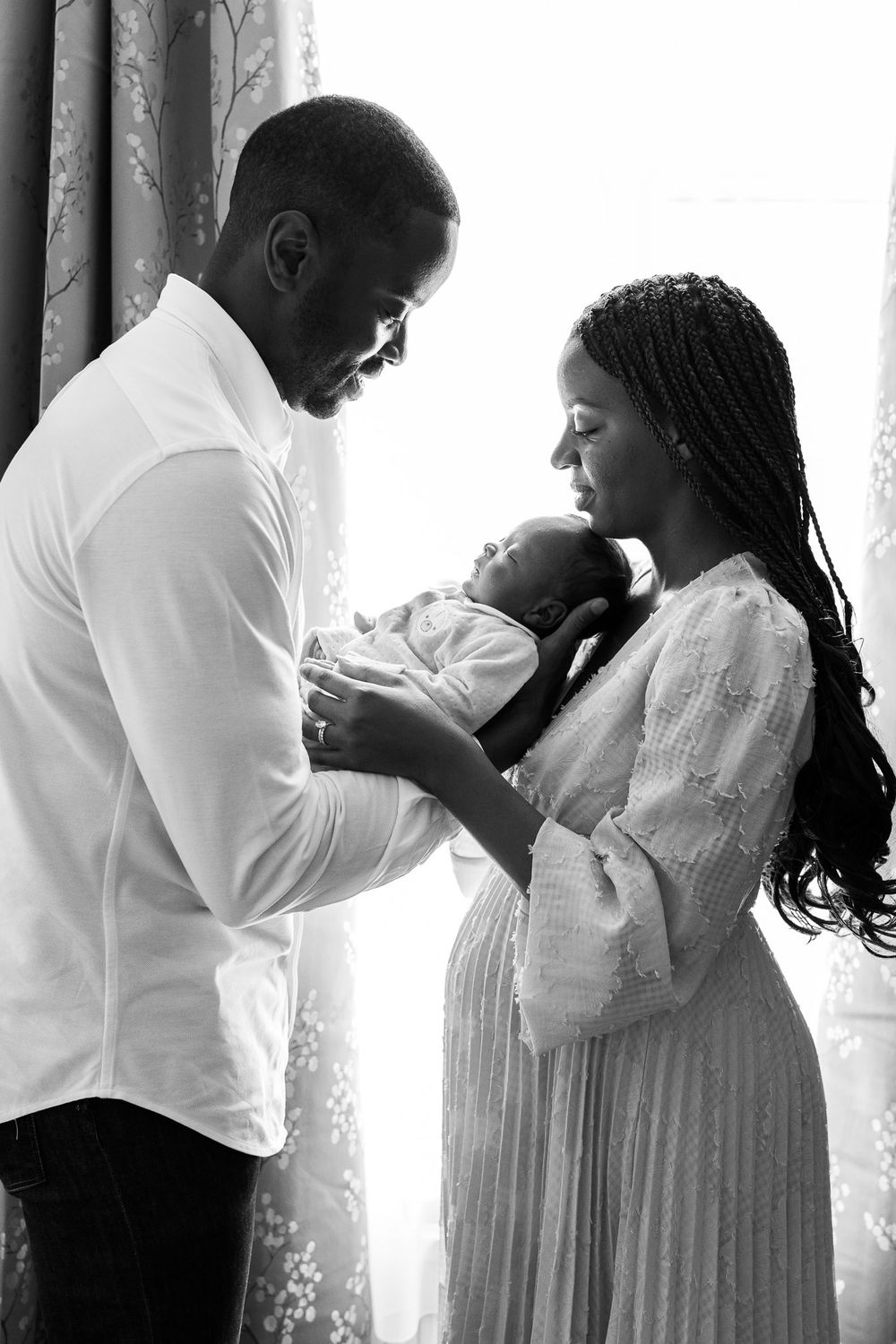Black and white silhouette or parents with baby