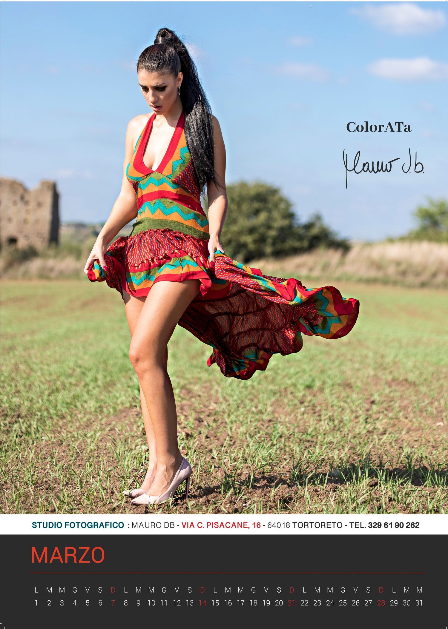 Fashion calendar photo of flowing red and green dress in outdoor setting for March.