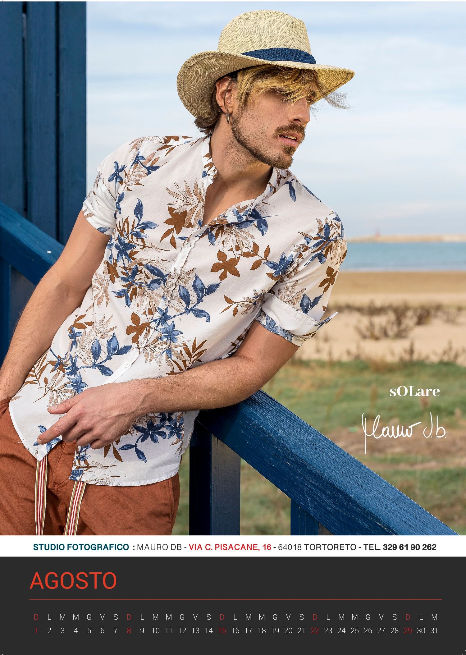 Fashion calendar photo showing tropical floral shirt and straw hat against coastal background for August.