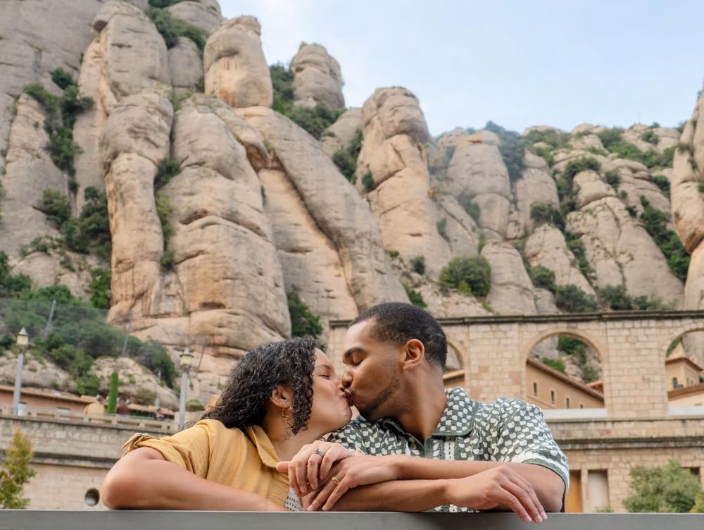 Couple sharing a romantic kiss at Montserrat mountain monastery in Barcelona, Spain.