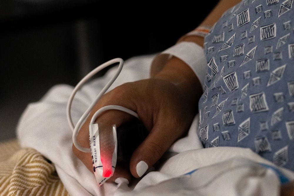 Medical monitoring equipment and IV tubes in a hospital setting.