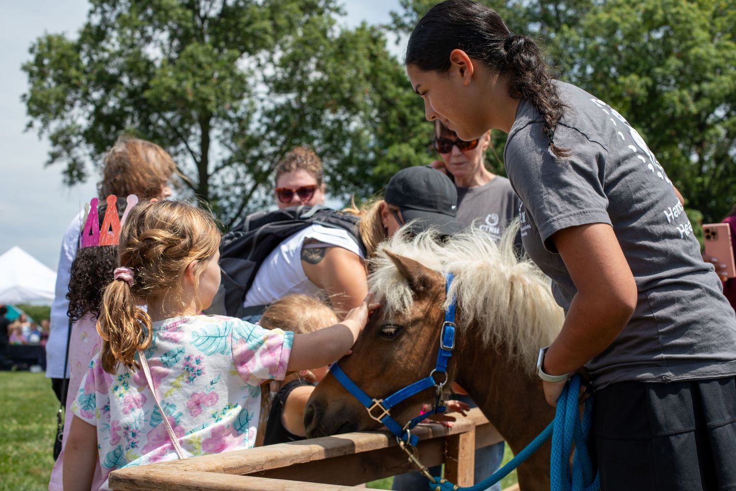 Kidchella Cincinnati family magazine event photo capturing pony interaction for luxury family lifestyle editorial