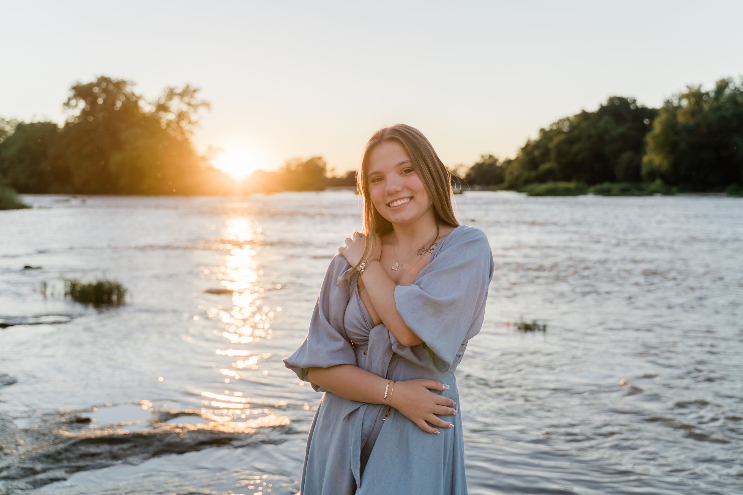 A series of sunset photos by the water showing a casual photoshoot in soft golden light.