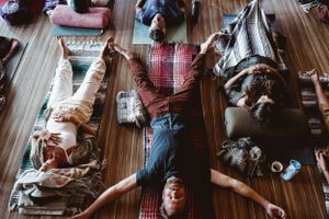 Participants lying in relaxation poses on mats during wellness session.