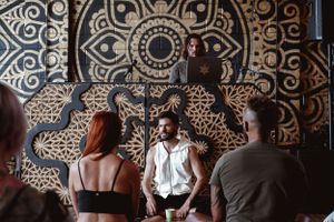 Wellness session in progress with decorative mandala backdrop in modern studio setting.