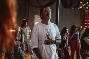 A candid moment during a lively dance event in an industrial-style venue.
