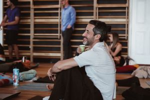 Participant enjoying a moment of relaxation during wellness session in studio space.