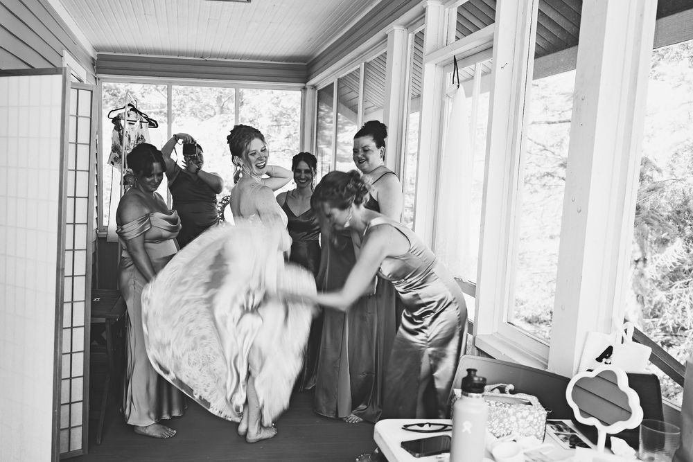 A wedding party celebrates in a series of joyful moments captured in black and white photographs.
