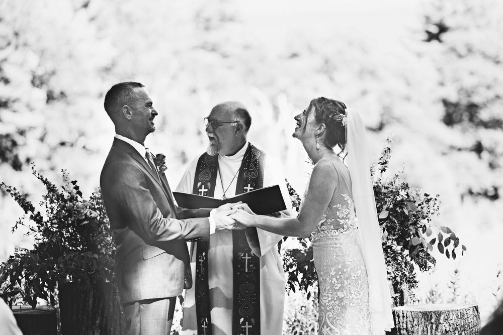 Black and white collage of outdoor wedding ceremony moments showing a couple exchanging vows and special moments.