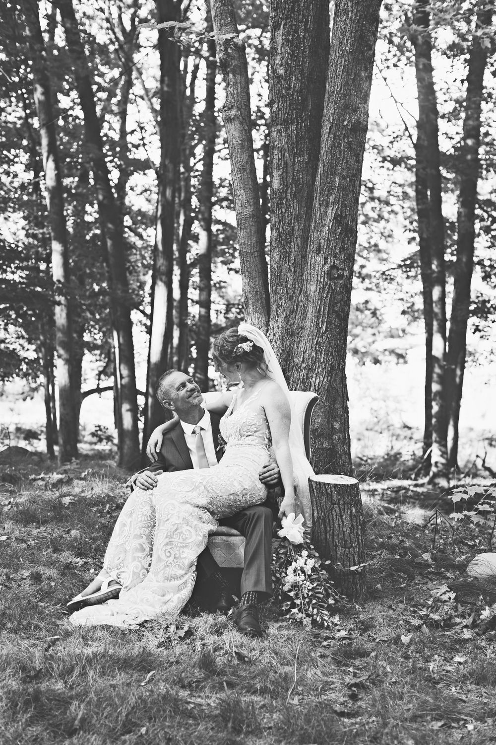Romantic black and white photograph taken in a serene wooded setting.