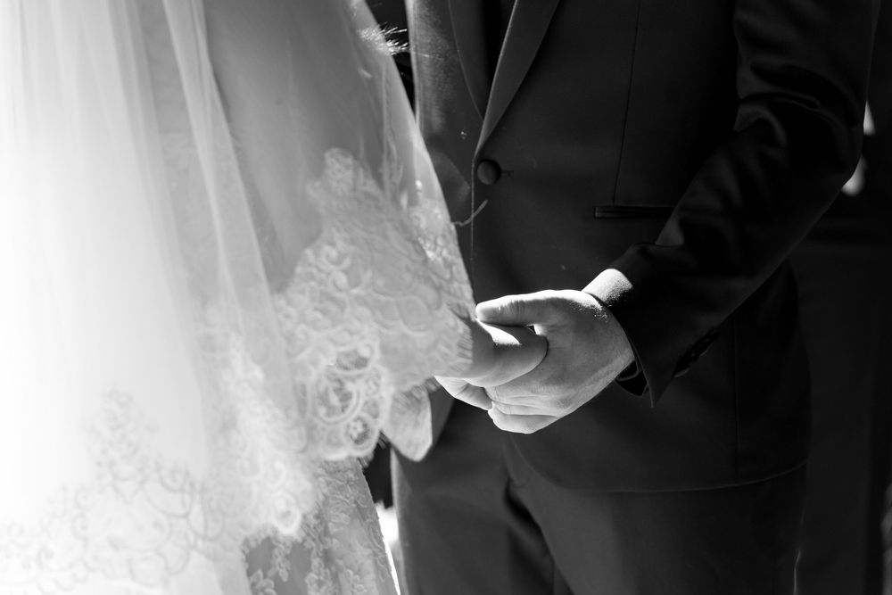 Black and white close-up shot of formal wedding attire.
