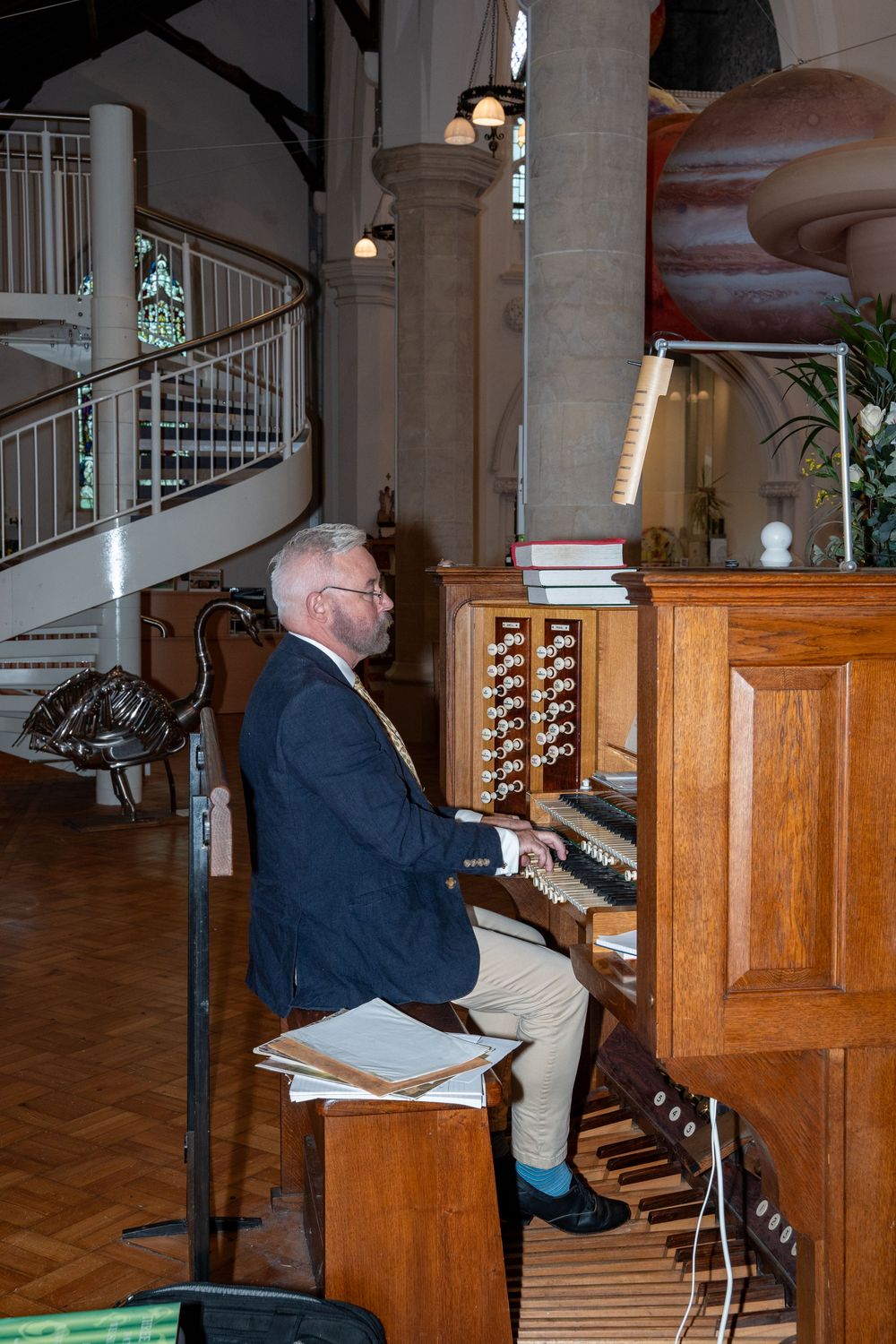 A church organist plays a wooden pipe organ in a series of sequential photos showing different angles of the performance.