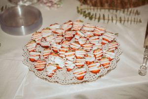 Orange and white patterned cookies arranged in a circular pattern on a lace doily.