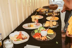 Appetizer buffet table with various plates of meats, cheeses, and vegetables.