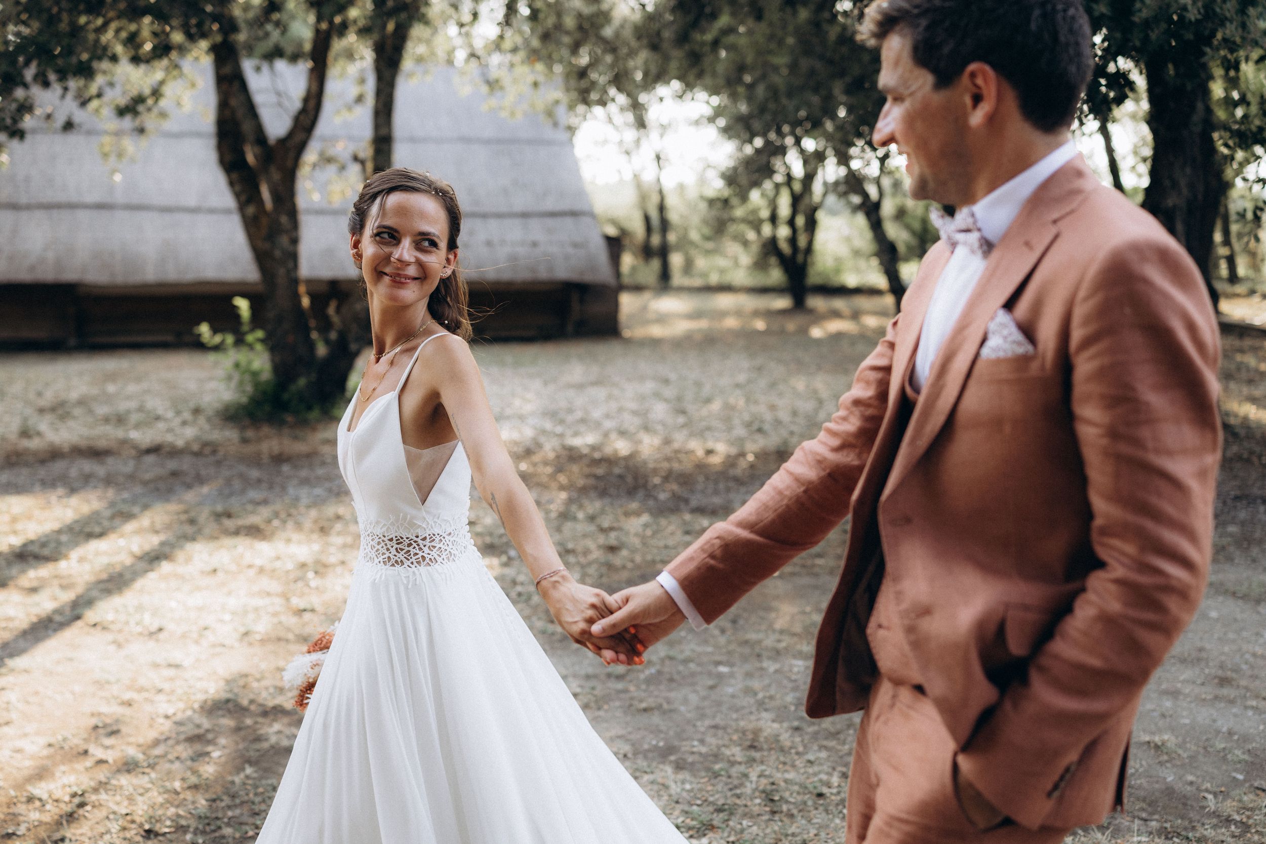 A romantic dance silhouette under stone archways with warm lighting.