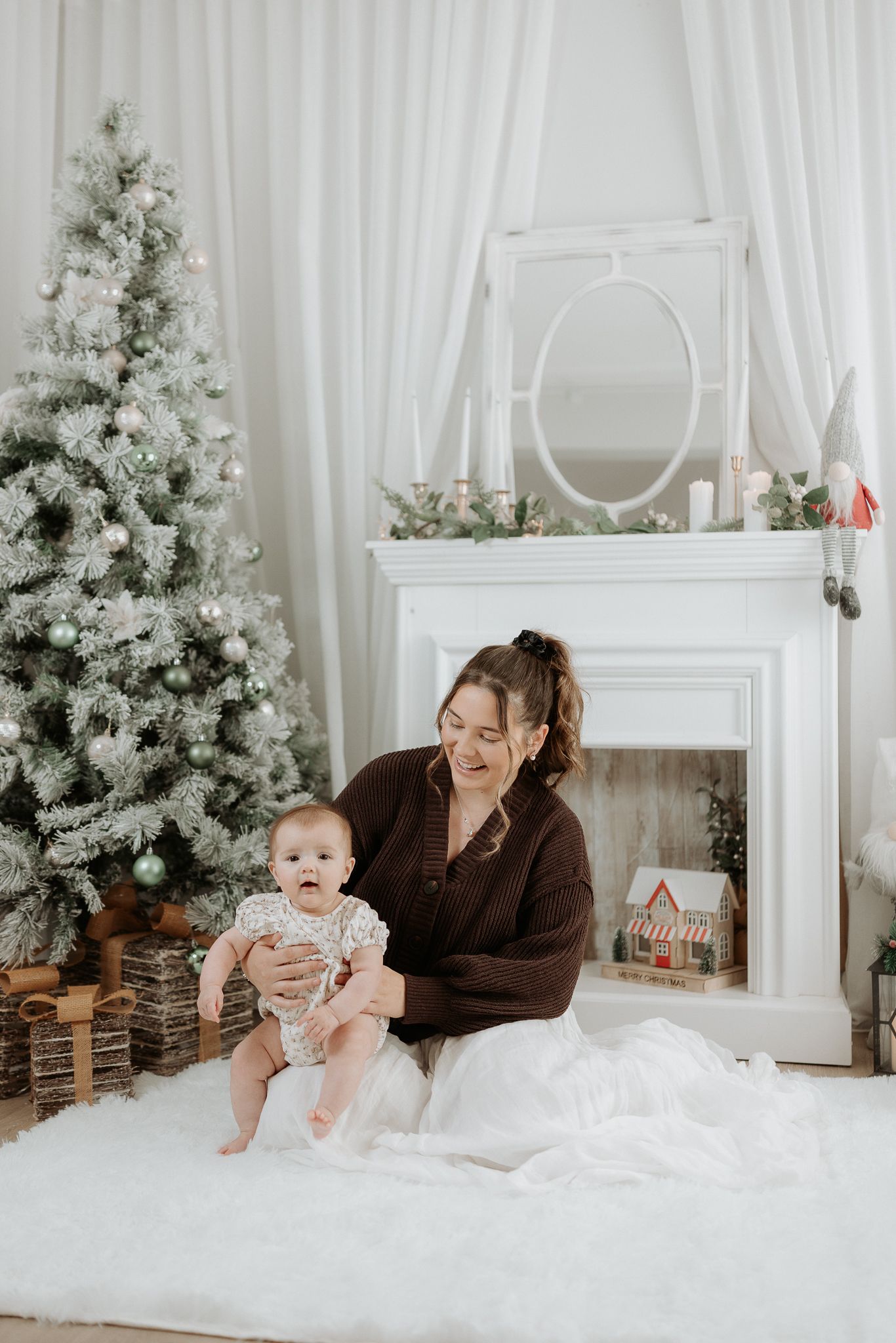 Four sequential photos show siblings sitting together in front of a white Christmas tree in neutral tones and soft lighting.
