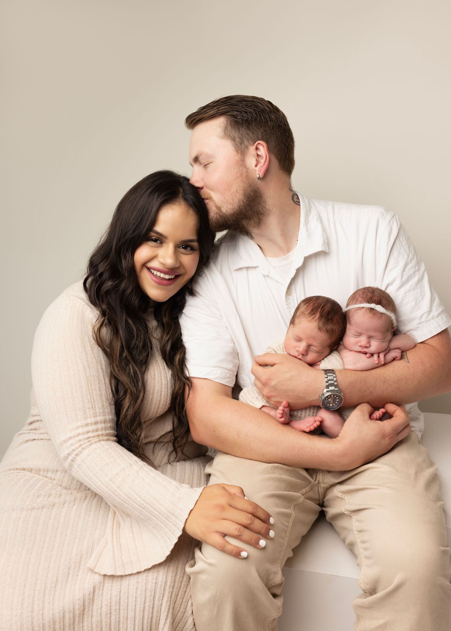 Dad holds newborn twins and mom snuggles in. Newborn Photos for Janina's Photo session Cloverdale Family Photos Elizabeth Lang Photography.
