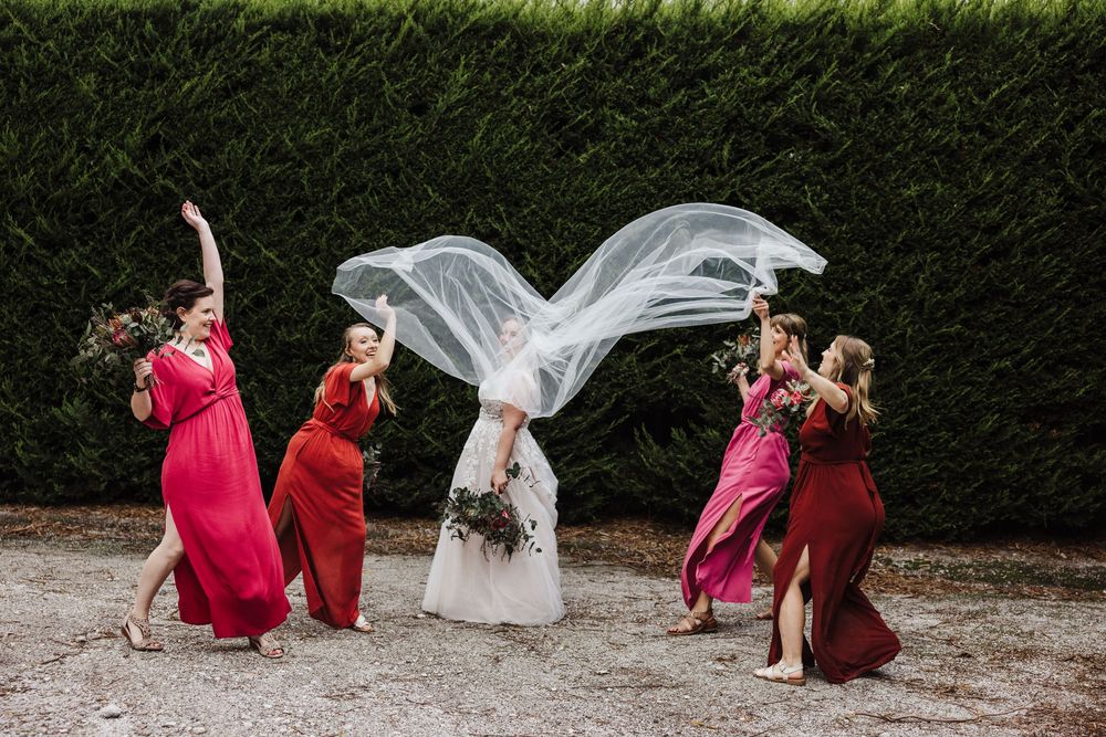 A sequence of artistic photos showing a wedding veil flowing in the wind while surrounded by bridesmaids in pink dresses.