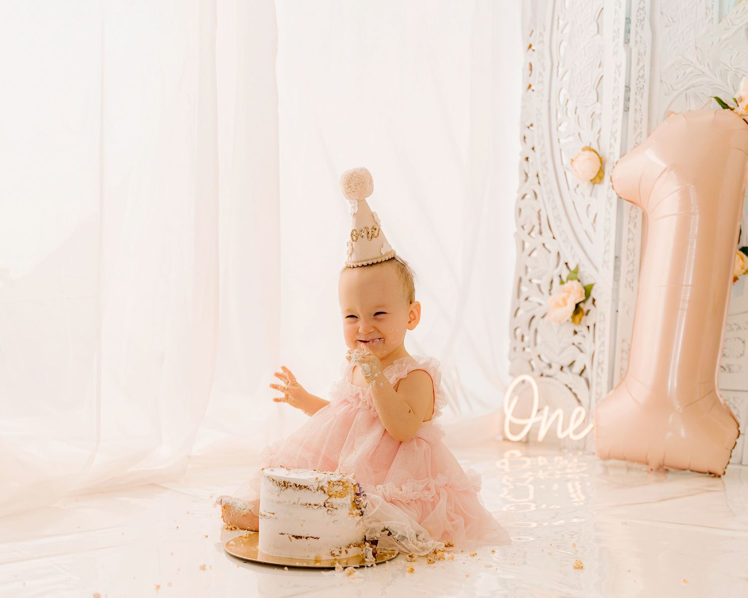 Magical woodland themed birthday setup with pastel balloon arch, mushroom decorations, and fairy-tale inspired accessories.
