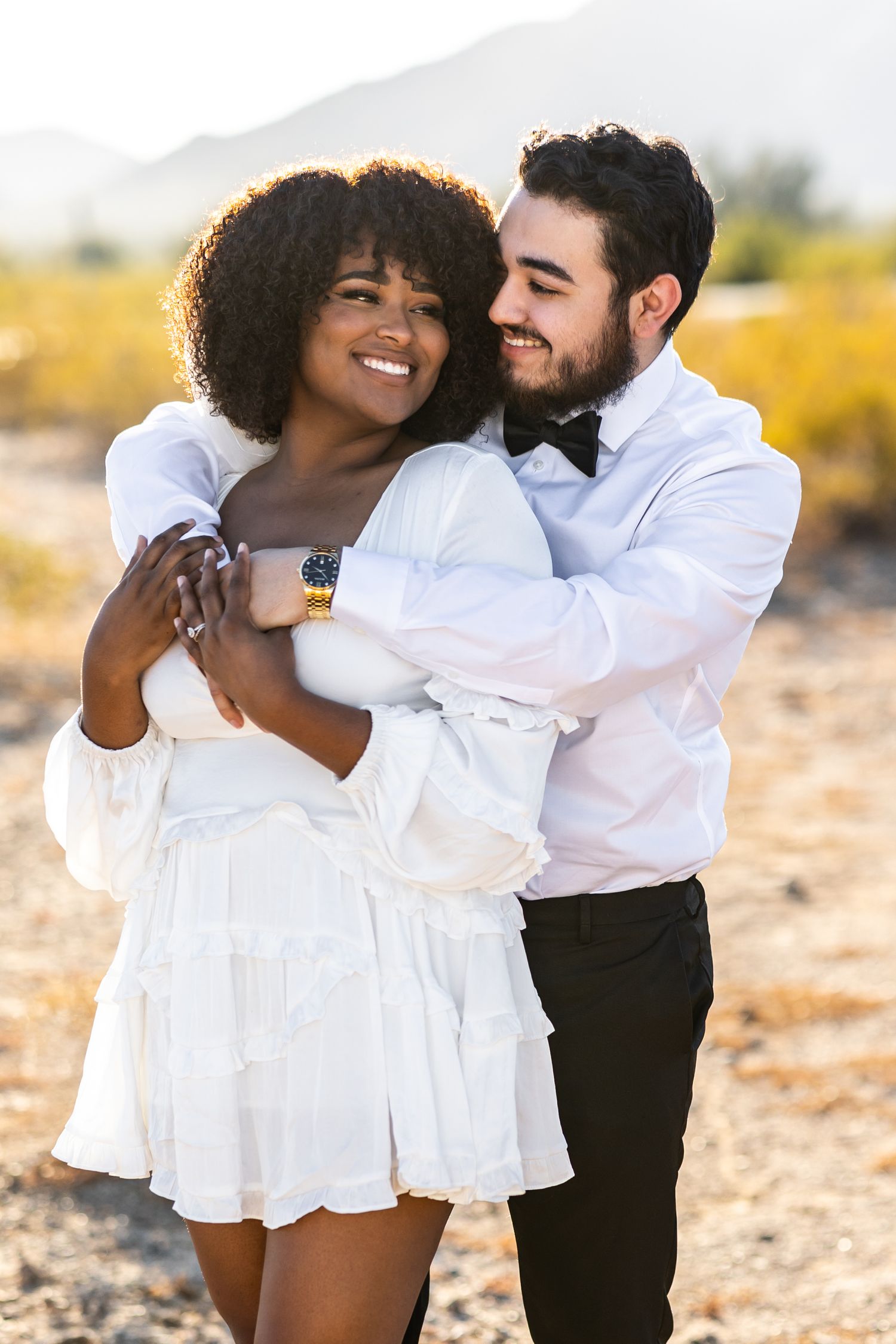A tender wedding moment captured showing a couple in white dress and grey plaid suit at their wedding at the Texas State Fair