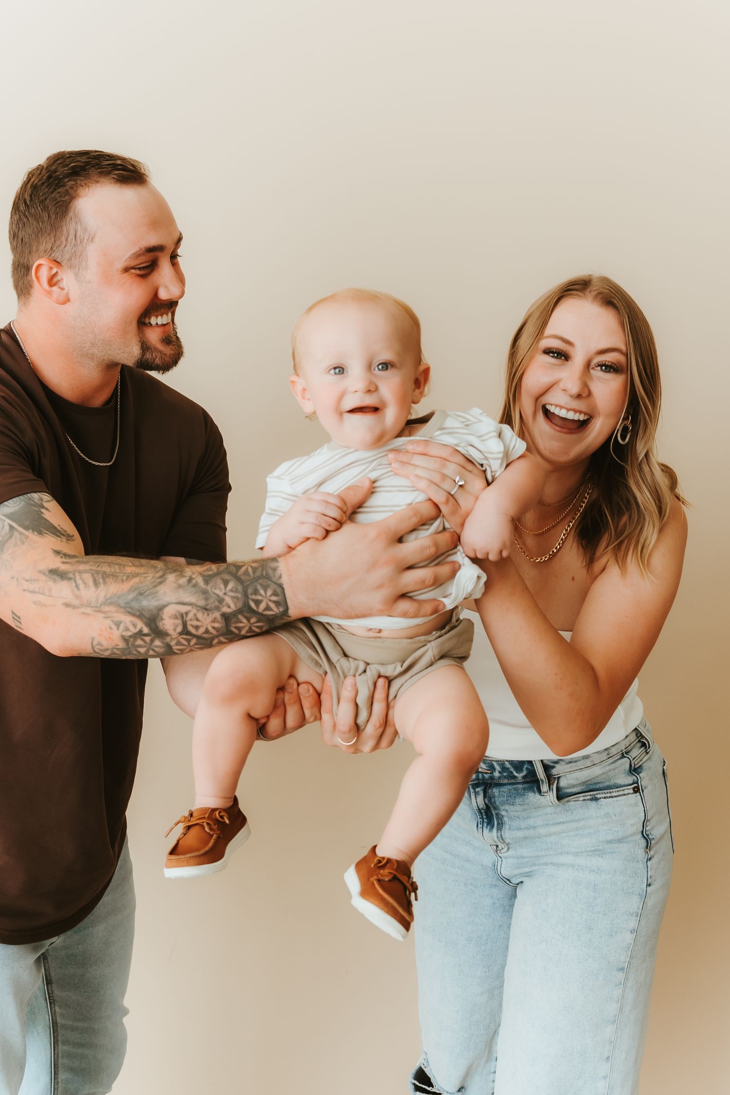 A playful series of photos showing joyful family moments with a baby being lifted and held against a neutral background.