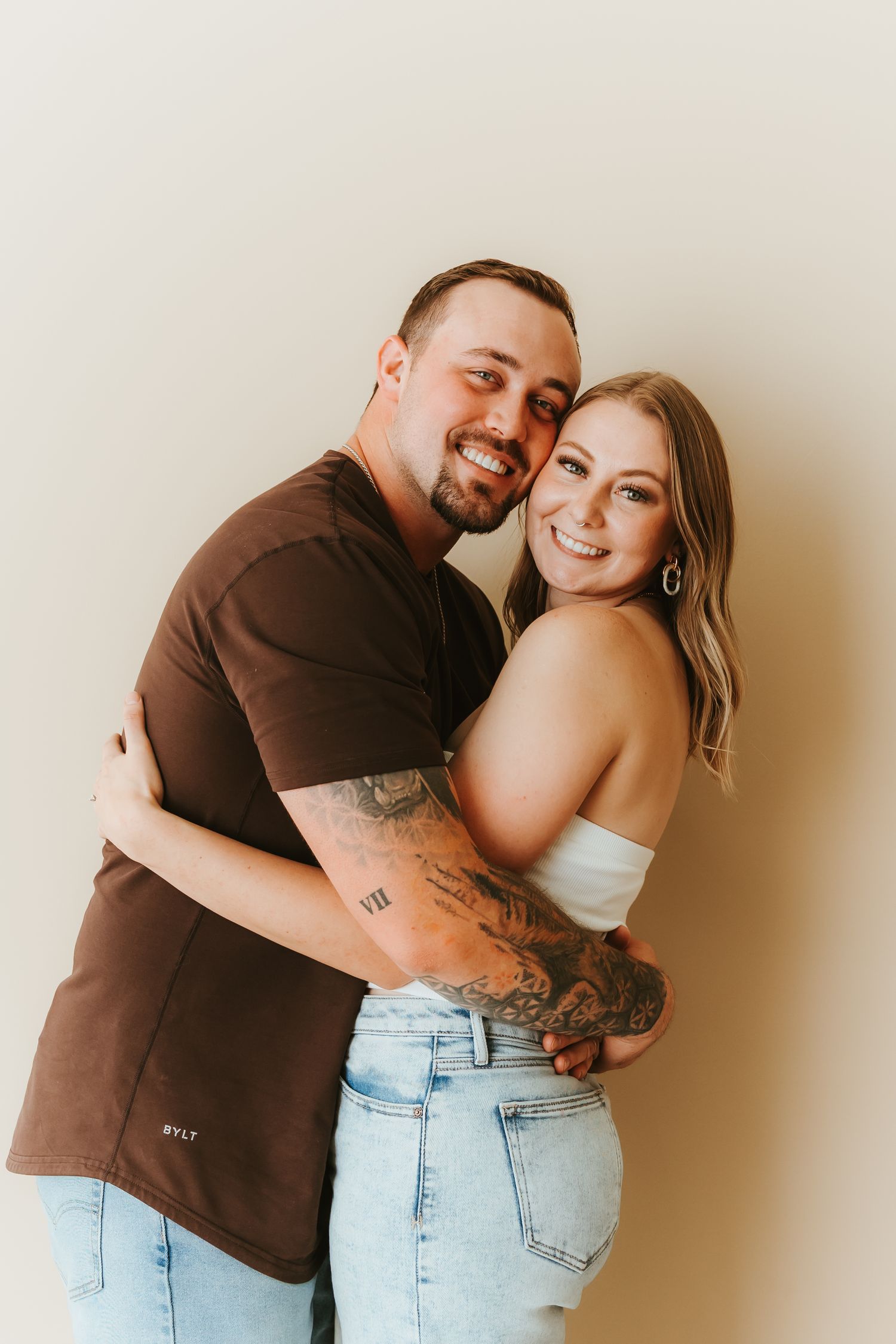 Sweet moments between a pair wearing brown shirt and light denim captured in a photo series.
