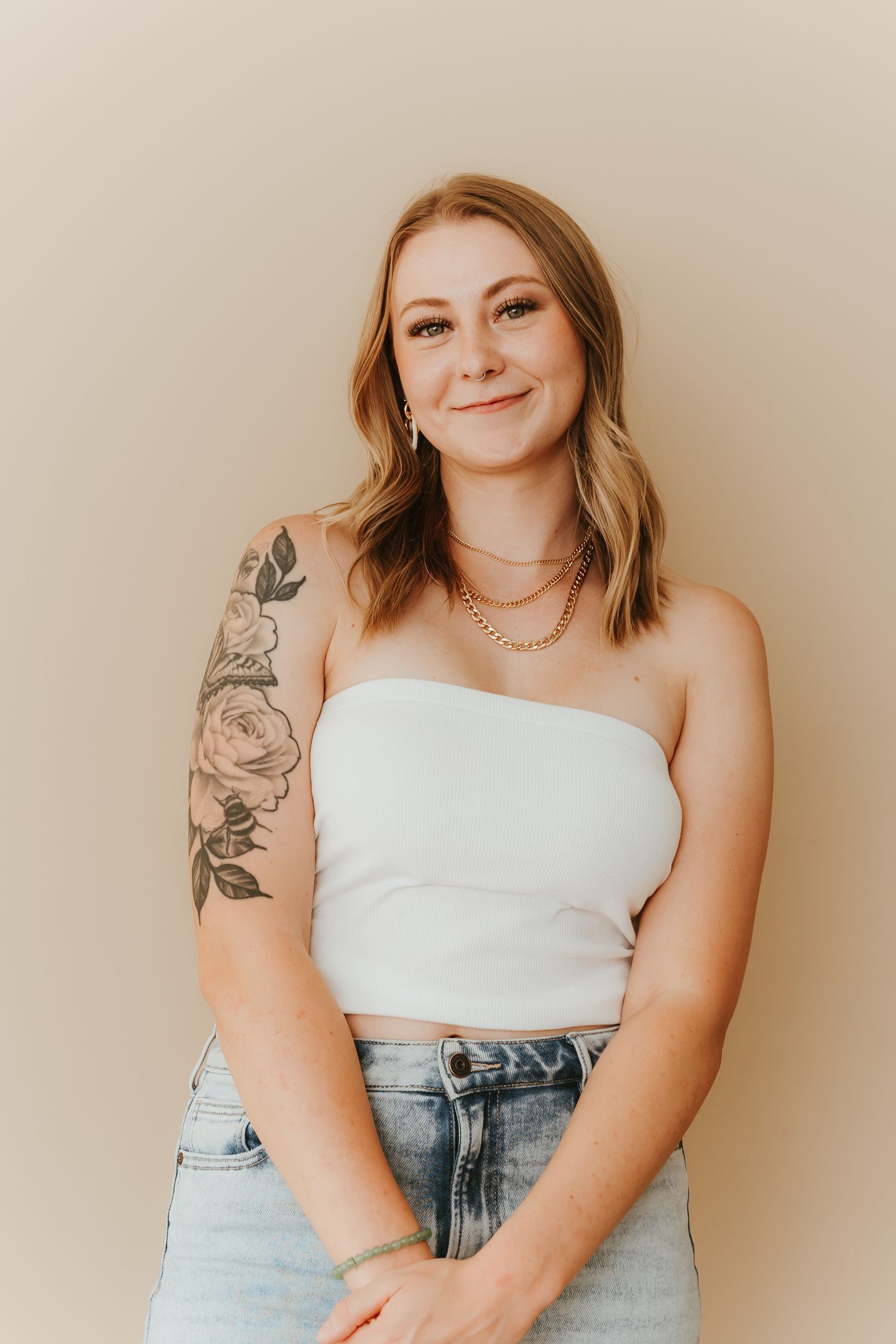 A sequence of casual portraits featuring someone in a white top and denim against a beige backdrop.