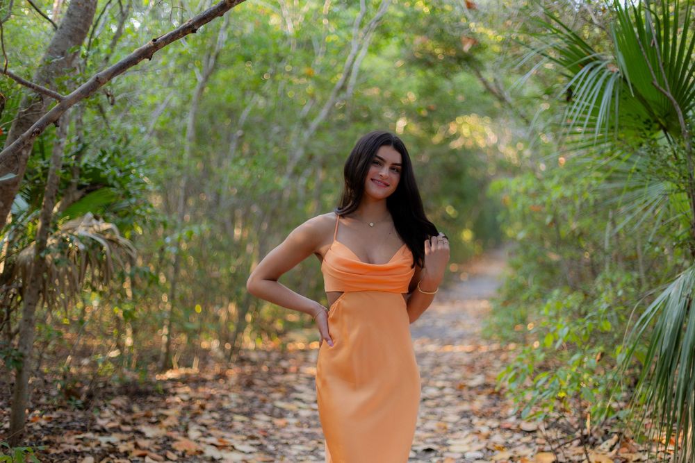 Girl posing for senior portraits at Hugh birch park