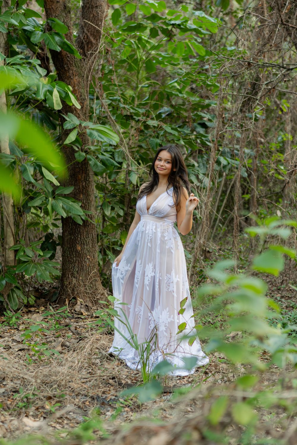 Girl posing for senior portraits at Tree tops Park