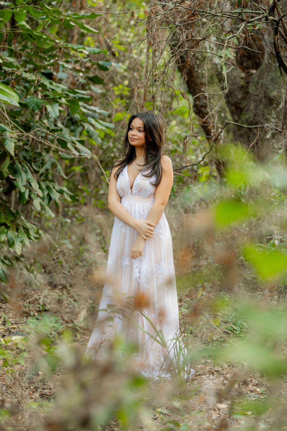 Girl posing for senior portraits at Tree tops Park