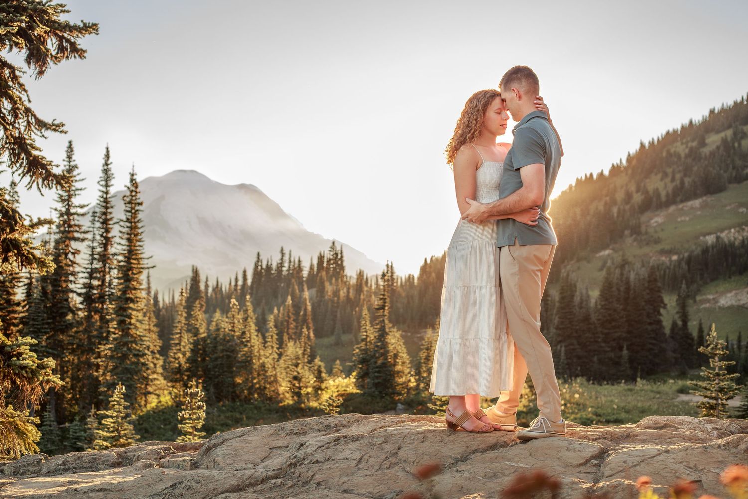 Engagement couple snuggling together during their adventure photo session in Mt. Rainier National Park near Seattle Washington