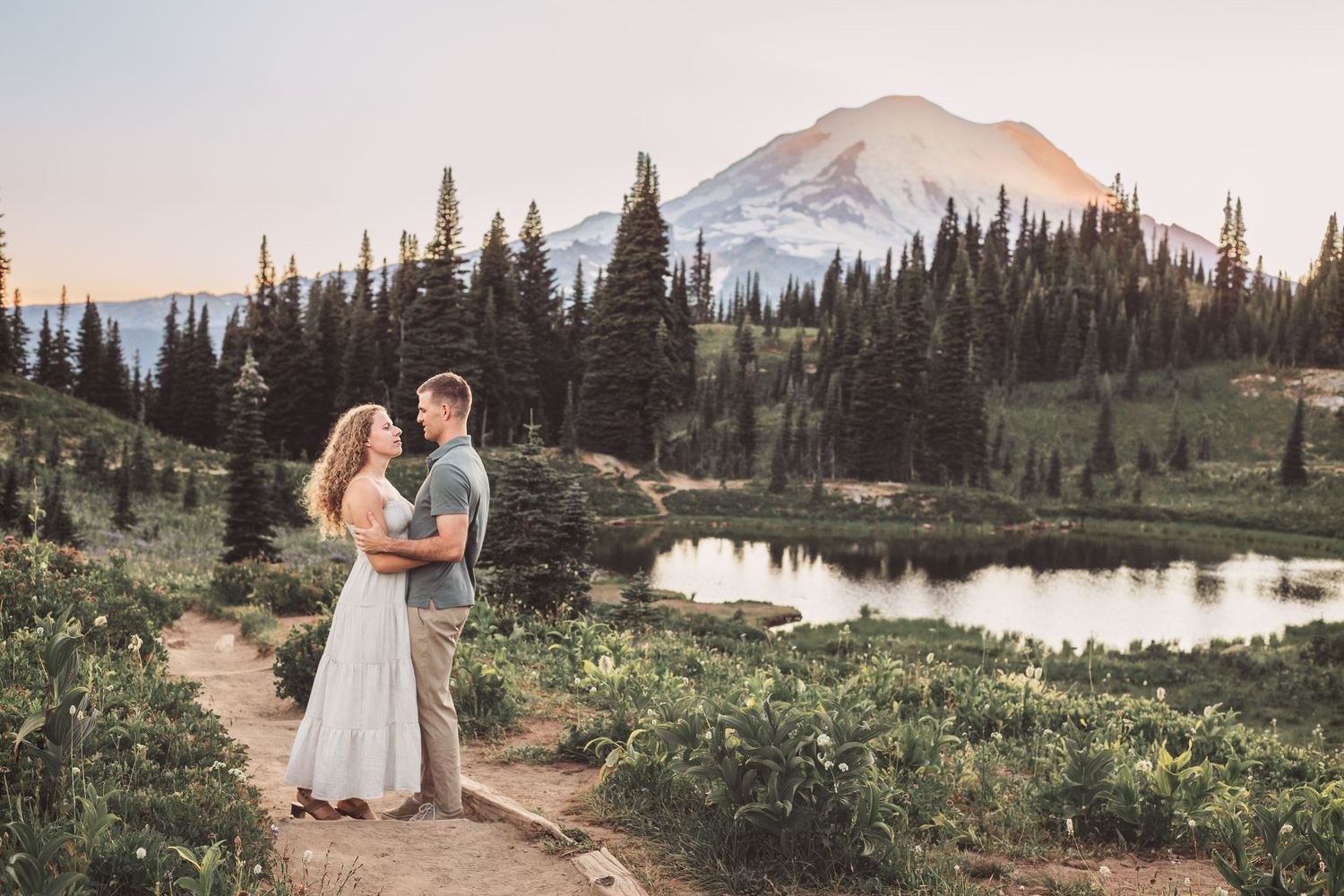 Engagement couple kissing together during their couples adventure photo session in Mt. Rainier National Park near Seattle Washington