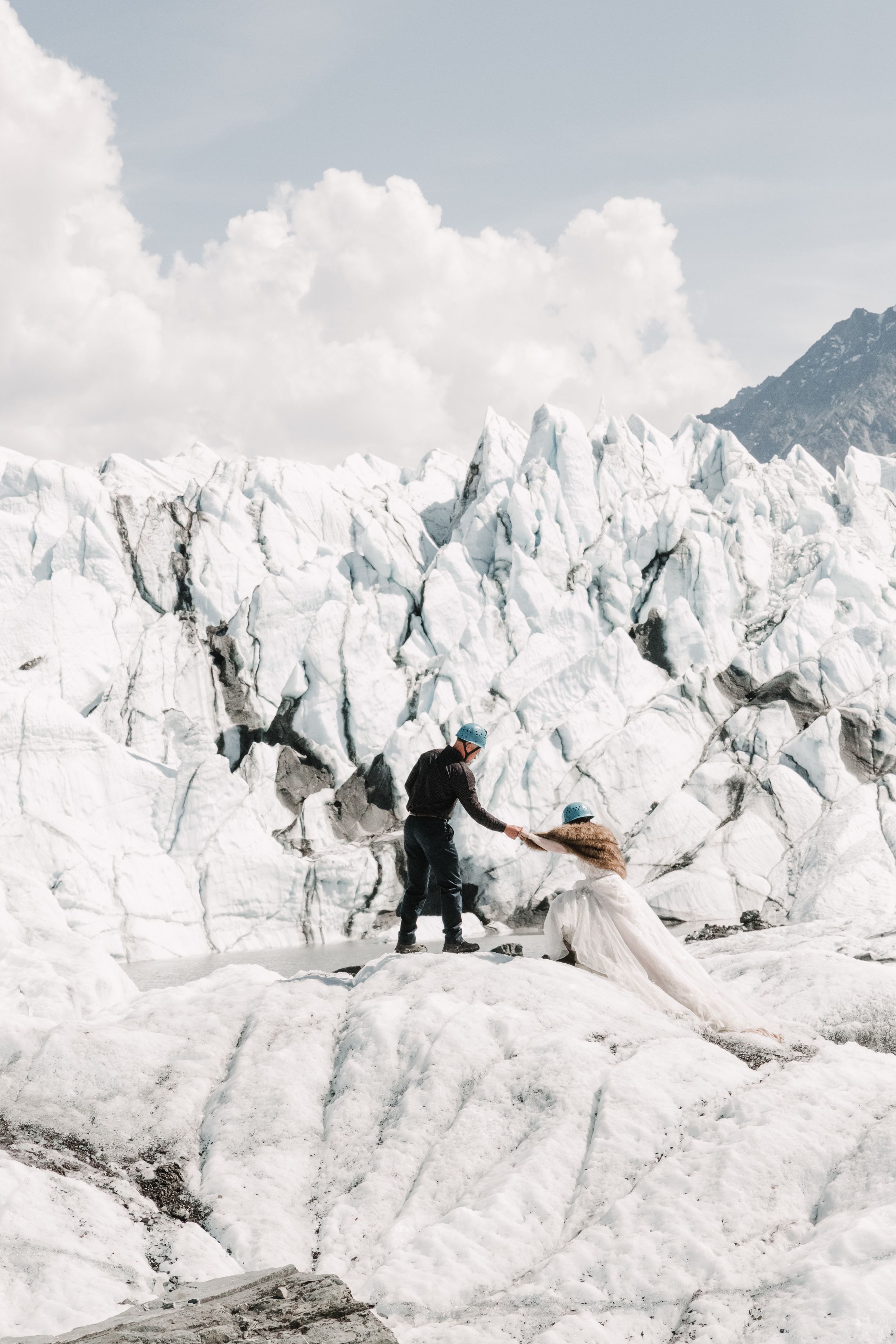 bride and groom hiking across a glacier for their Wyoming elopement
