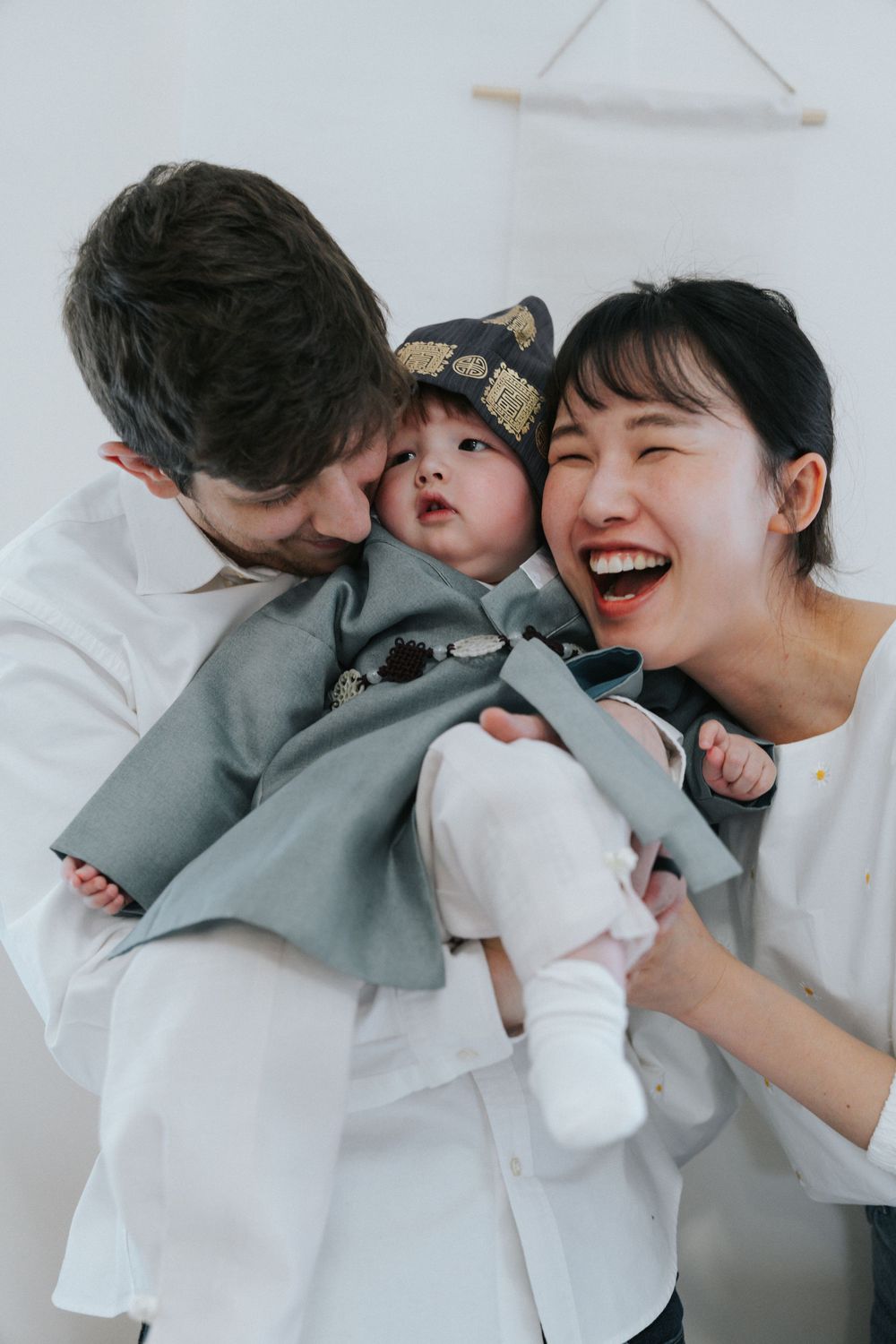 A series of candid photos showing a happy family sharing joyful moments together while lounging in bed.