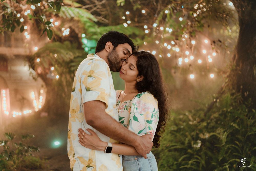 A romantic evening photoshoot in a garden with twinkling fairy lights creating a magical atmosphere.